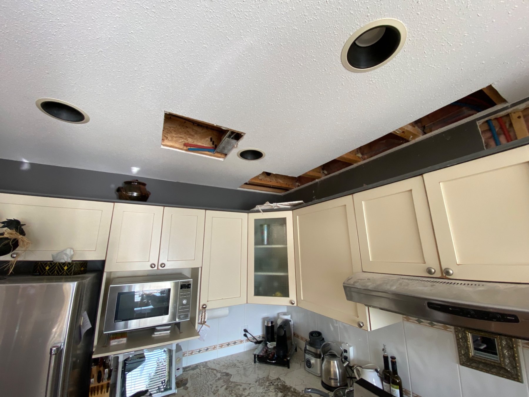 Kitchen ceiling openings after a Poly-B repipe, West Kelowna